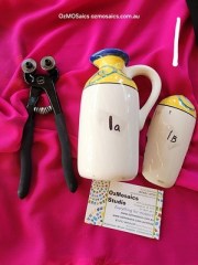 Halved cream ceramic jug with blue rim, yellow accents, and green leafy swirls – mosaic-ready